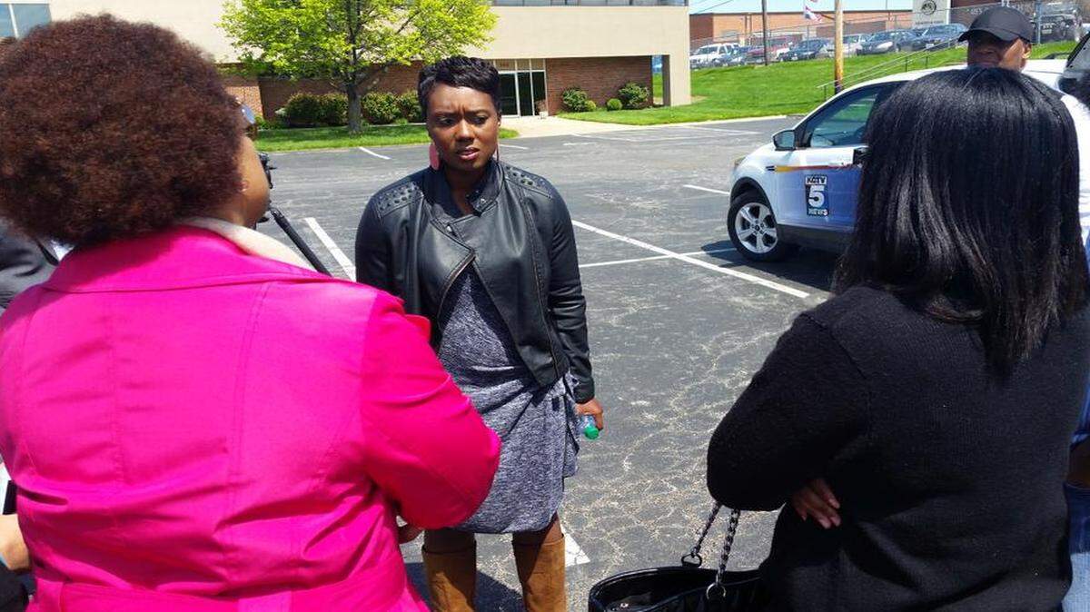 
Pam Smiley (center), a volunteer track and field coach at Lee’s Summit High School, speaks with supporters Wednesday after being told a decision to relieve her of her duties by head coach Karen Sanders would stand. Smiley alleges that Sanders told her last week that the only reason some minority members of the team were having successful track seasons was because Smiley was African-American and the athletes could relate to her. Sanders resigned from her position Wednesday.
