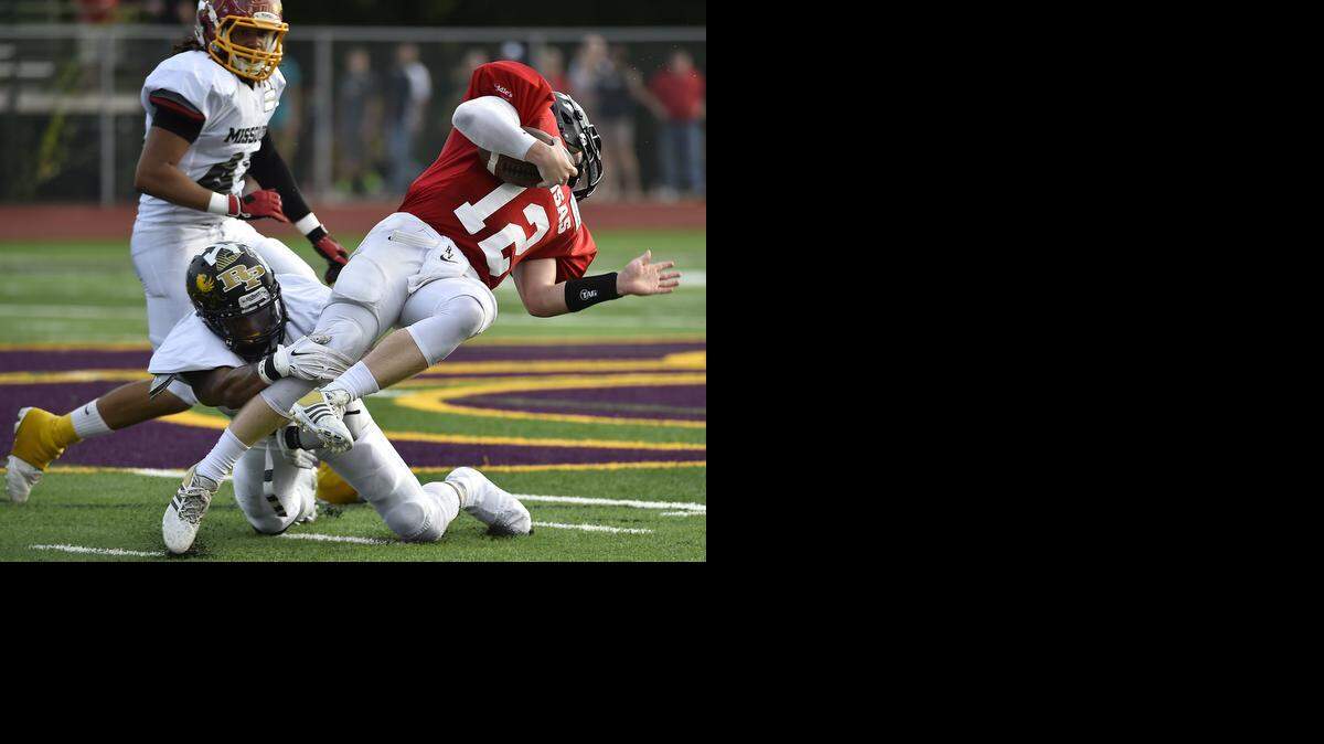 
Logan Brettell (with ball) of Blue Valley High School looks for a few more yards against Raymore-Peculiar's Marcus Zweifel last week in the Greater Kansas City Football Coaches Association Kansas vs. Missouri All-Star Game at Blue Springs High School.
