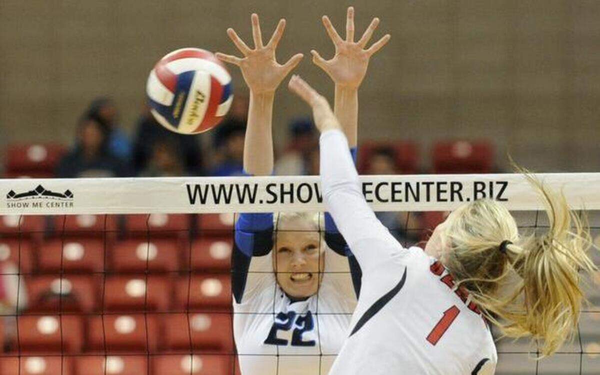 
Liberty’s Morgan Fleming tried to block a spike from Ozark’s Kendra Sater in the third-place game in the Class 4 state volleyball tournament.
