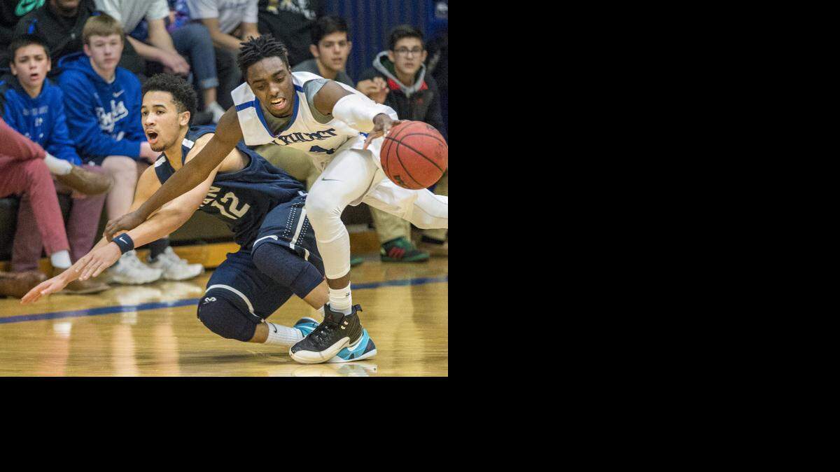 
Rockhurst’s Will Bazzle (right) and Lee’s Summit West’s Gary Davis scrambled after a loose ball during their game Friday night at Rockhurst High School.
