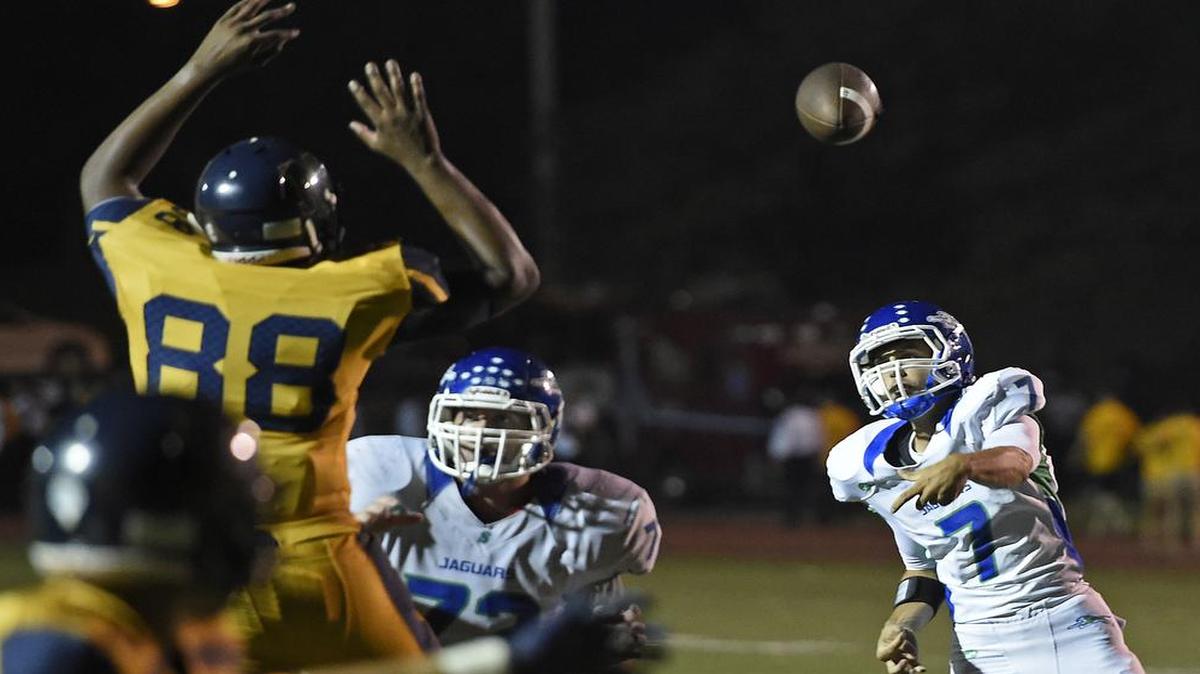 
Blue Springs South’s Noah Nigro fires a touchdown pass over Liberty North’s Mike Hughes during the second half of their game Friday at William Jewell College.
