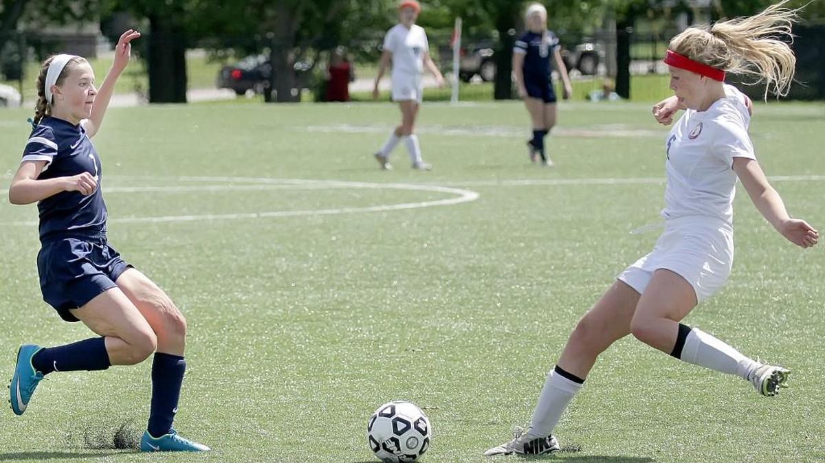 Trinity Academy’s Elise Alexander (left) and Bishop Miege’s Hannah Belfield went for the ball during Saturday’s game 4A in Topeka. Belfield had a goal in Miege’s 4-0 win.
