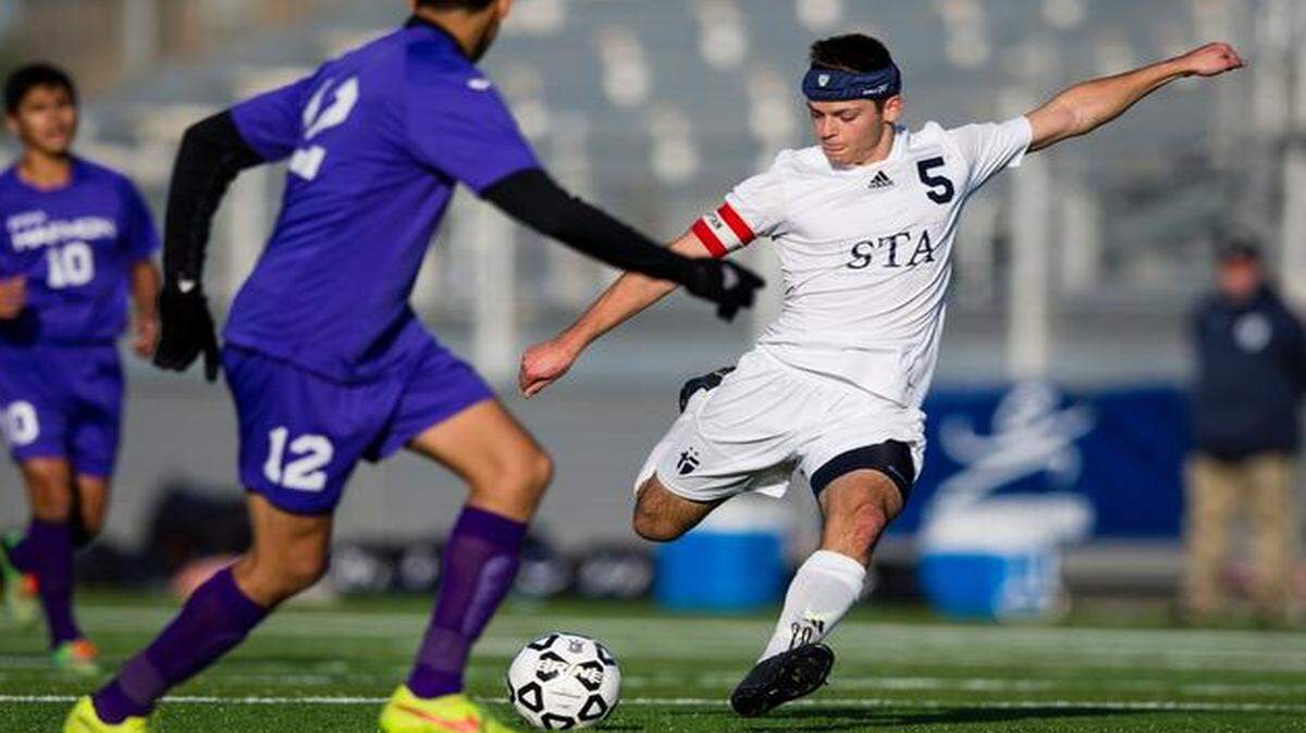 
St. Thomas Aquinas’ Luke Kutey, who scored two goals, got off a shot against Harmon’s Jesus Corral in Saturday’s Kansas Class 5A title game.
