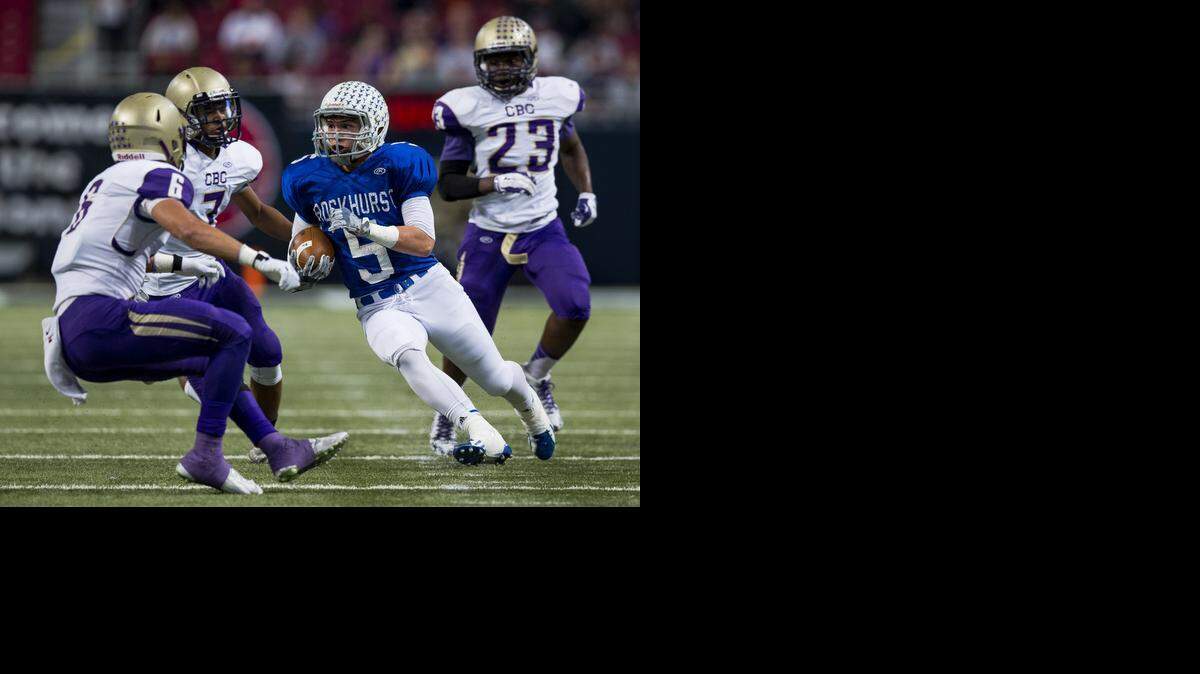 
Lance Boehm (with ball) of Rockhurst High School worked for yardage after his catch against CBC defenders on Saturday in the MSHSAA Class 6 state championship game at the Edward Jones Dome in St. Louis.
