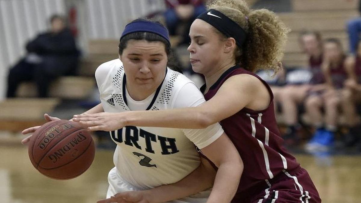 Blue Valley North’s Micaela Delagarza (left) was fouled by Lee’s Summit North’s Alexis Griffin during their game last week in the KA-MO Classic tournament at Blue Valley North High School. Delagarza scored 44 points in the game.