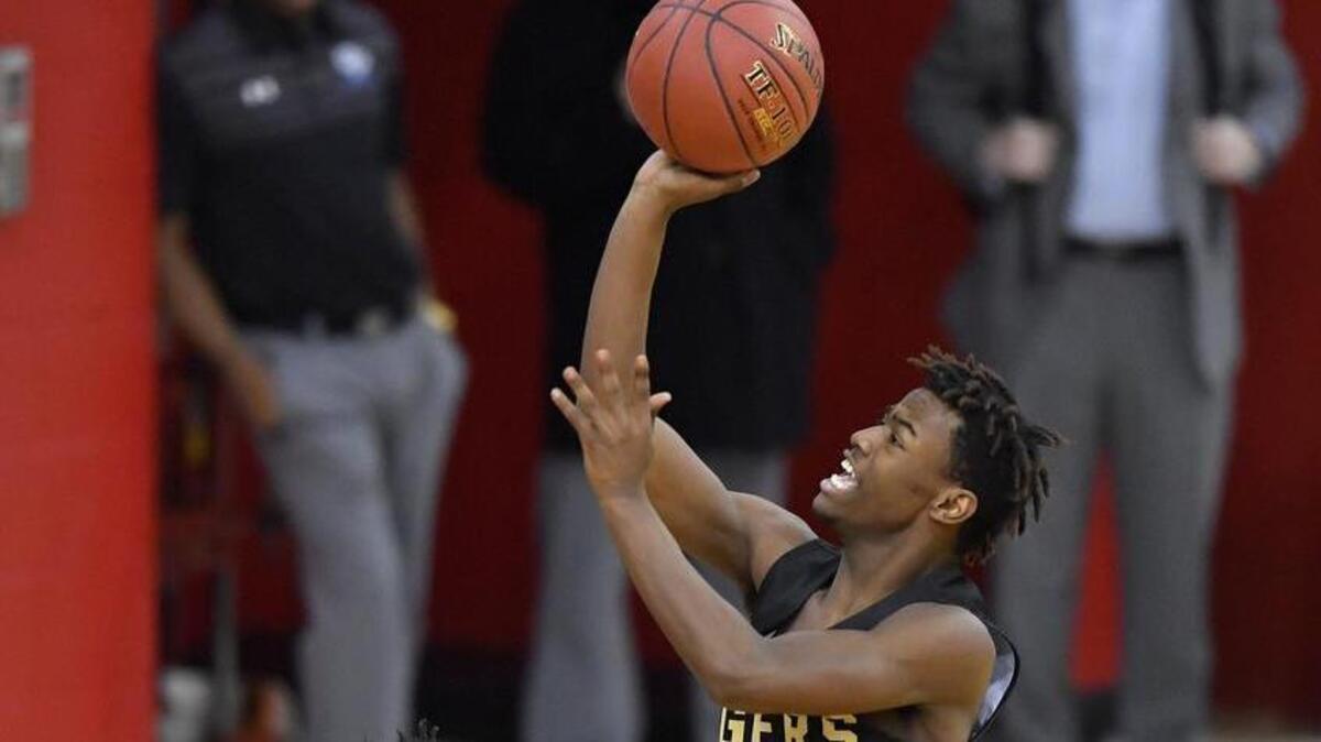 Lee’s Summit’s Nate Jones got the ball to the basket against the Park Hill South defense in a game Wednesday at the William Jewell Holiday Classic.