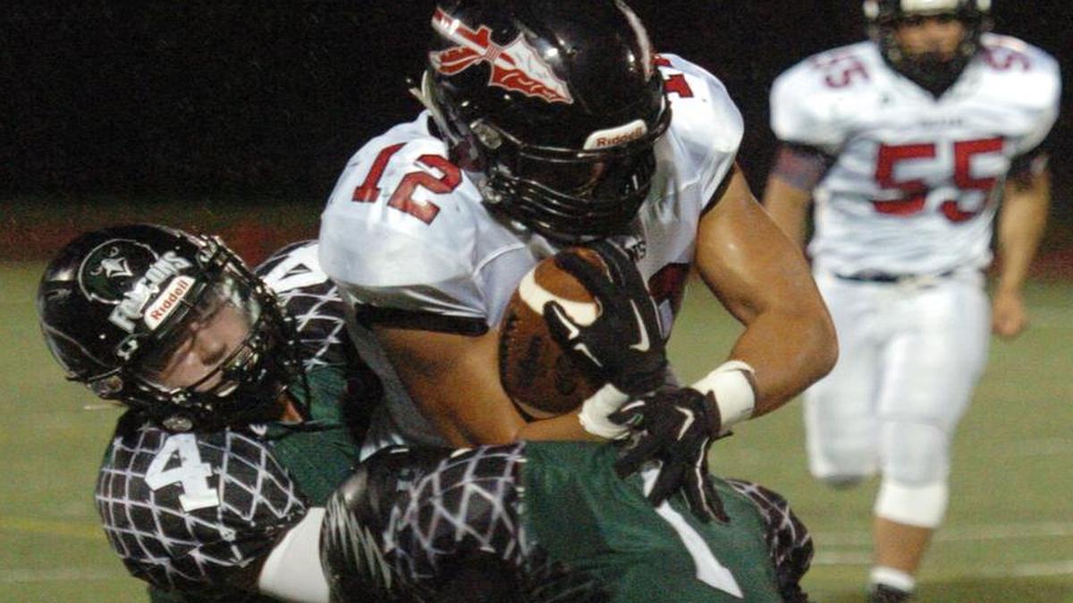 
Staley defenders Hunter Heyne (left) and Roderick Criss (right) brought down Fort Osage’s Isaiah Iloilo on Friday night. Fort Osage prevailed 17-14.
