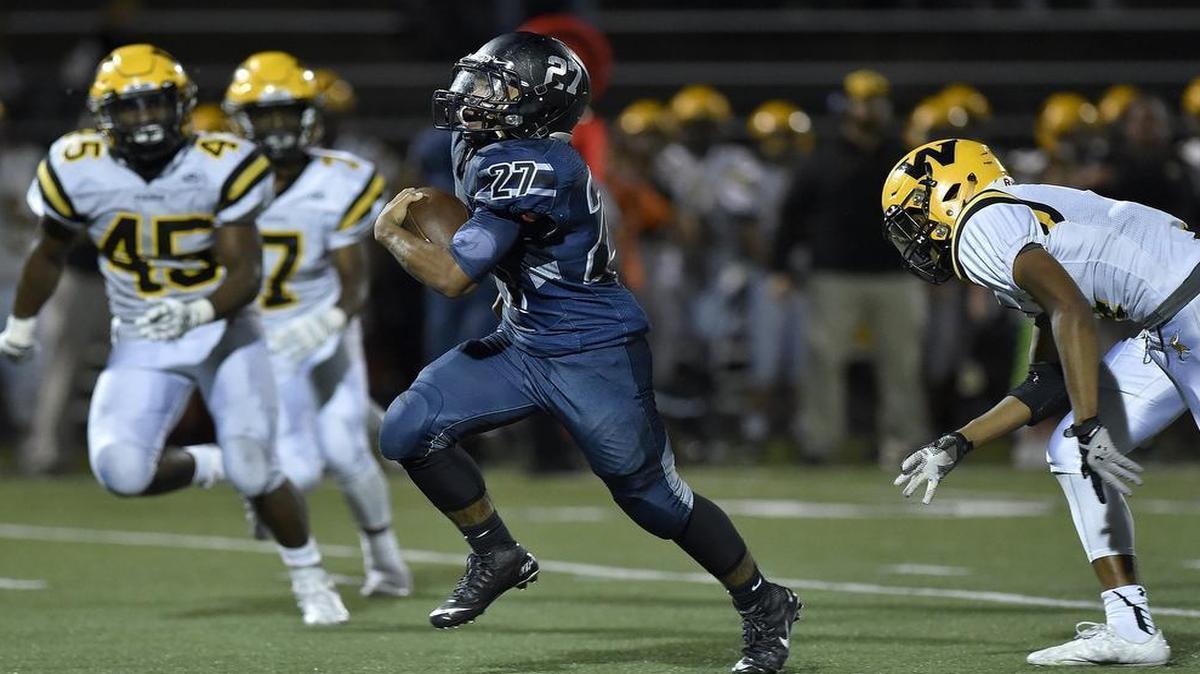 Blue Valley North’s Tony Bragulla (center) broke free for a second-half touchdown against Shawnee Mission West on Friday night at the Blue Valley District Activity Complex.