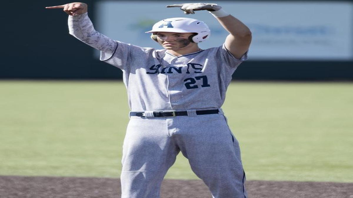 St. Thomas Aquinas’ Riley Pint celebrated at second base after hitting a double to score two go-ahead runs during the fifth inning Saturday at the Kansas Class 5A baseball state tournament championship game. St. Thomas Aquinas won the game 14-9.