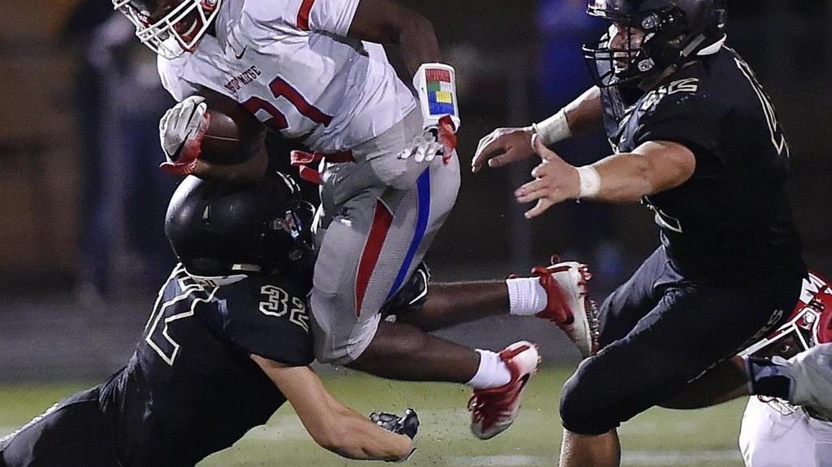 Blue Valley's Michael Maffry (right), the East Kansas League’s defensive player of the year, recorded 183 tackles for the Tigers.