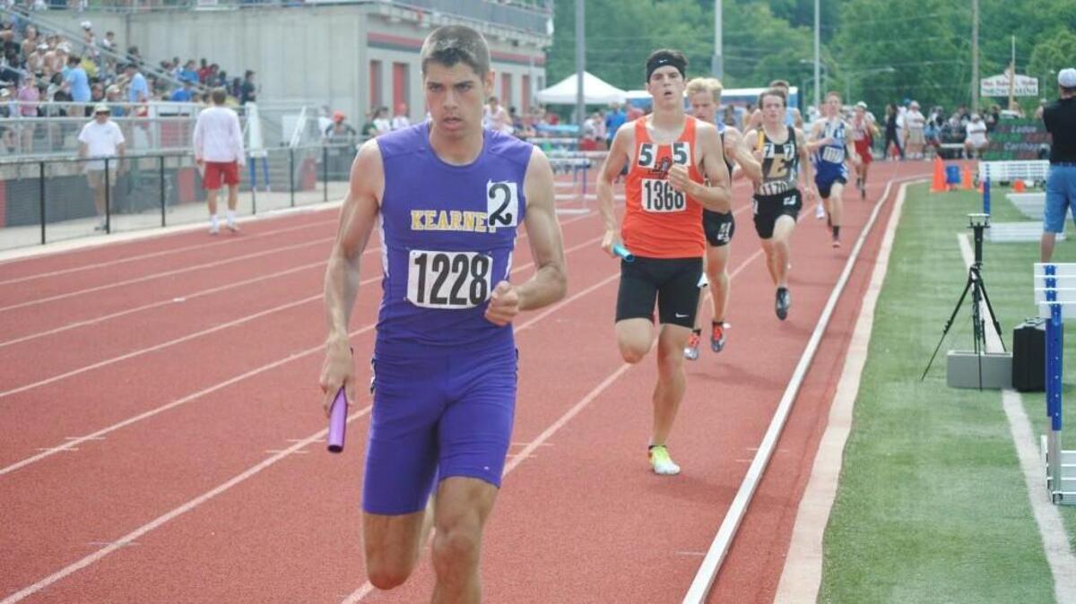Clayton Adams of Kearney stays ahead of Keegan Cordova of Platte County during the anchor leg of the Class 4 boys 3,200 relay. Kearney won the race and Platte County finished third.