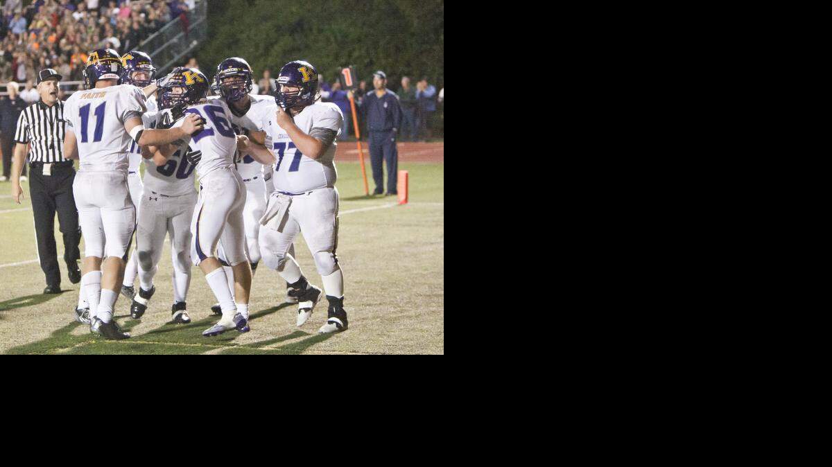 
Kearney teammates surround running back Reagan Frakes after he scored the game’s only touchdodwn on Friday night against Liberty North at William Jewell College. Kearney won the game 9-3.
