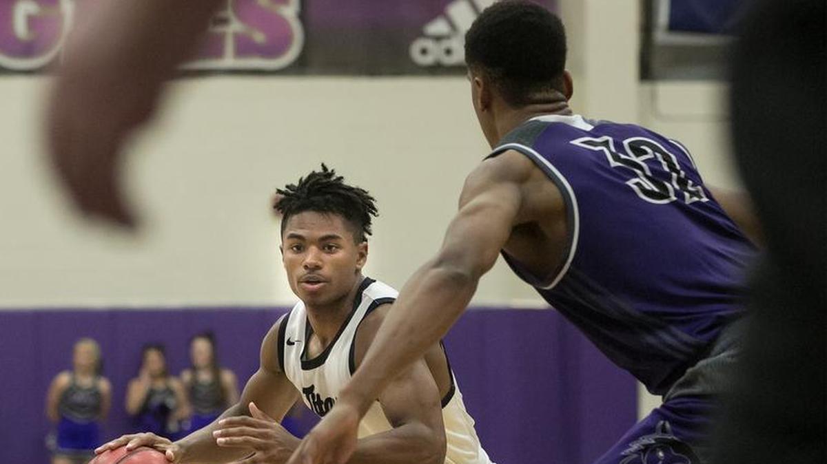 Lee’s Summit West’s Phillip Brooks (left) looked to drive against the Blue Valley Northwest defense in the Cable Dahmer Shootout on Saturday night at Avila College.