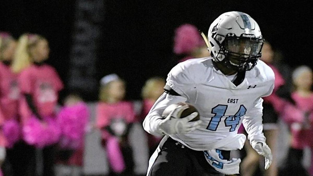 Shawnee Mission East’s Nigil Houston escaped from Lawrence’s Ekow Boye-Doe in the first half during Friday’s high school football game in Lawrence, Kansas.