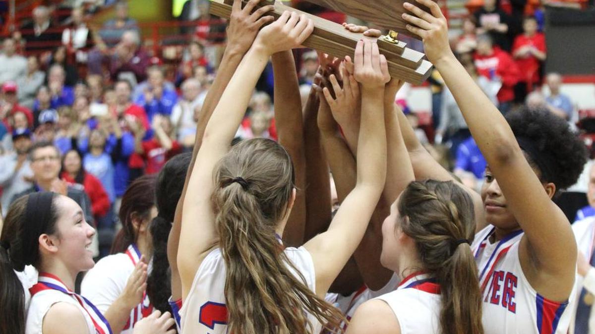The Bishp Miege girls team holds up its championship trophy Sat. March 12, 2016 at the Bicentennial Center in Salina.