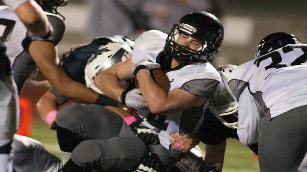 Lee’s Summit North running back Chase Swisher looked for running room against the Lee’s Summit West defense during their game on Friday night.