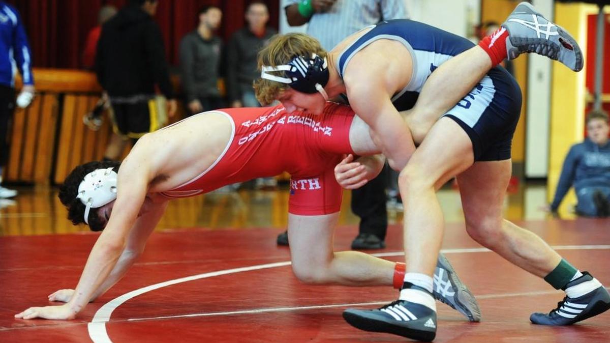 Blue Valley North's Andrew Nettelblad (right) maneuvers Jacob Alcantar of Wichita North like a wheelbarrow in a 160-pound weight class match during the Shawnee Mission North Invitational wrestling tournament Saturday. Nettelblad won the match on his way to a third-place finish.