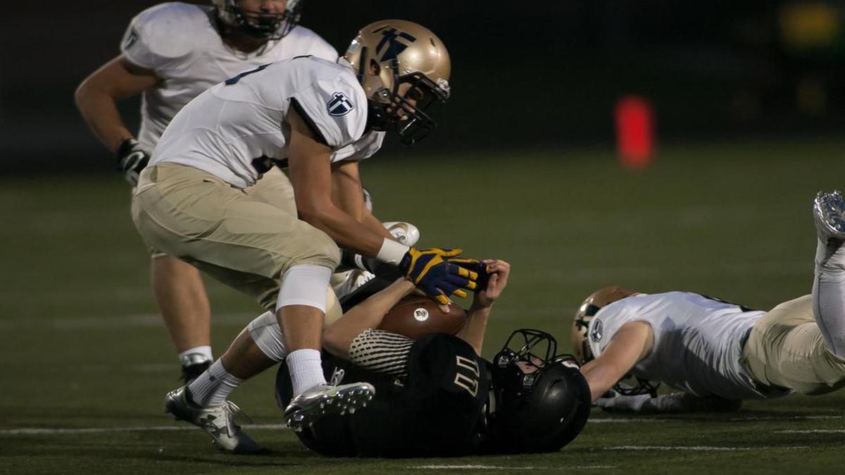 
St. Thomas Aquinas linebacker Ryan Jurczak sacked Blue Valley Colton McCumber for a loss in the first quarter of their game on Friday night. The Saints defeated Blue Valley, 35-13.
