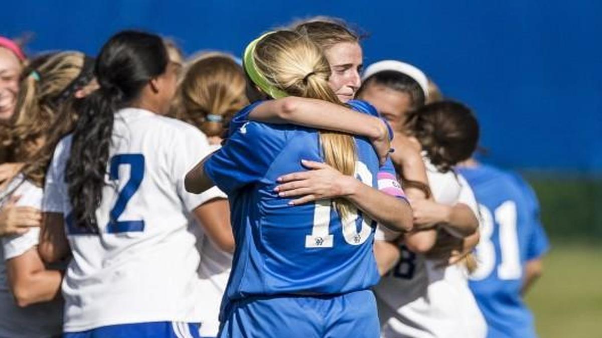 Pembroke Hill’s Kealy Kornitzer (8) and Caroline Peterson (10) hugged while Duchesne players celebrated a 4-1 victory at the Missouri Class 2 state soccer tournament Thursday at Swope Soccer Village.