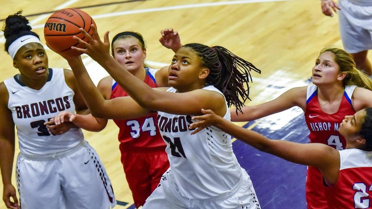 Aiyana Johnson (center) has helped Lee’s Summit North to a 17-0 record so far this season. The Broncos beat Bishop Miege at the Hy-Vee Shootout.