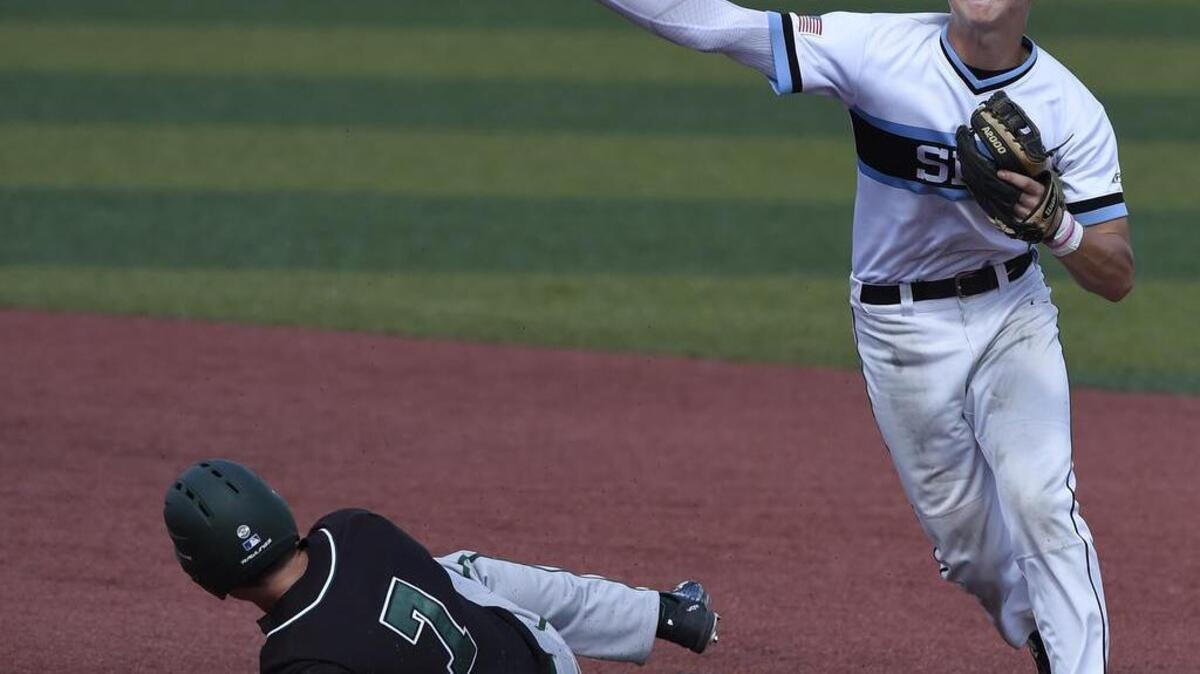Shawnee Mission East shortstop Trevor Thompson started a double play as Lawrence Free State baserunner Jacob Pavlyak slides into second during Saturday's Kansas State High School 6A Championship game in Lawrence last year. The Lancers won 4-3 in nine innings.