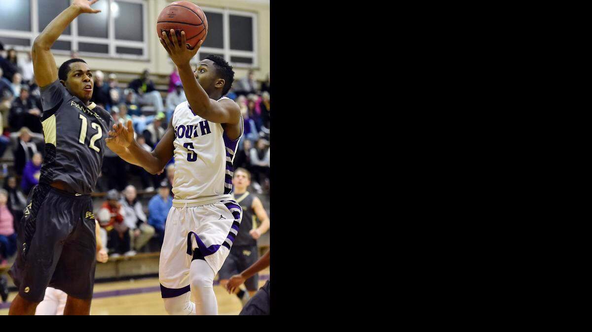 
Raymore-Peculiar High School senior Jason Chambers (left) looked to block a shot attempt by senior James Byrd of Park Hill south during second-half action of their game on Friday night in the championship game of the North Kansas City Invitational. Raymore-Peculiar won the game, 54-48.
