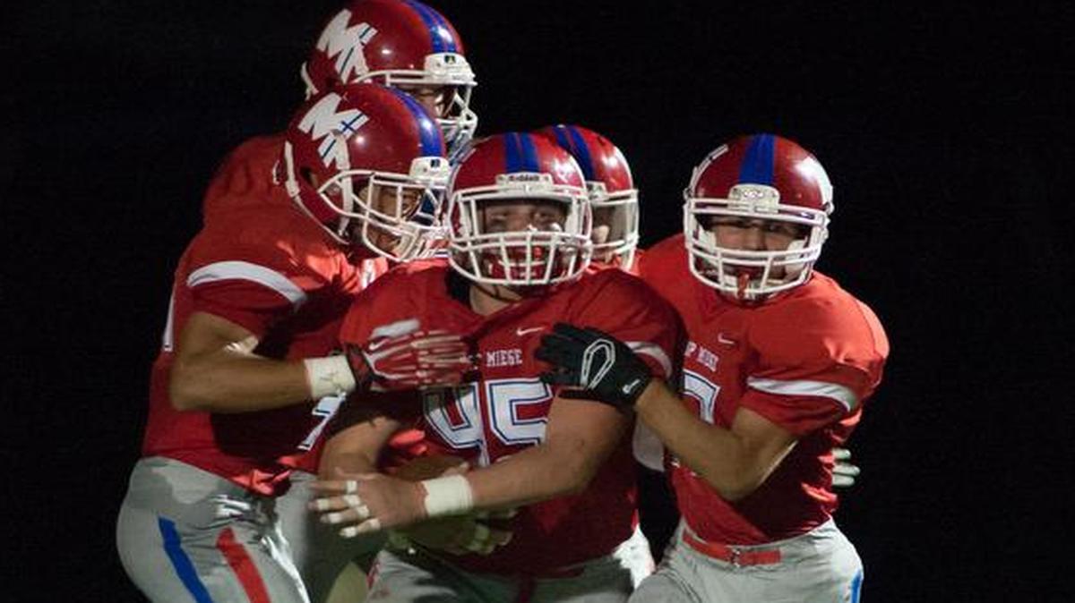 
Bishop Miege sophomore Joe Watskey (No. 45) celebrates with teammates after blocking a punt, scooping up the ball and running 38 yards for a touchdown in the second quarter on Friday night against St. Thomas Aquinas.
