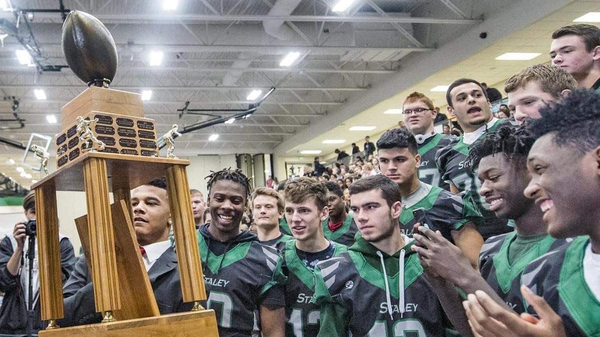 Julian Ross, a senior running back at Staley High School, showed his football teammates the Thomas A. Simone memorial award he won in 2016.