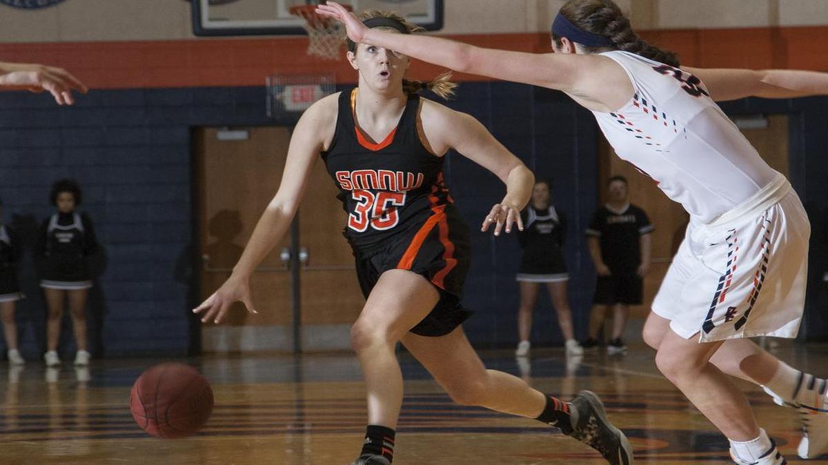 Shawnee Mission Northwest’s Brenni Rose looked to dribble around Olathe East defender Cameron Kincaid during first-half action in their game Tuesday, SM Northwest won the game, 41-32.