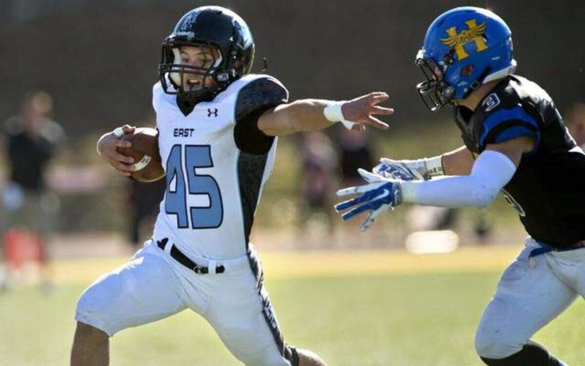 
Mike Bamford of SM East picked up yardage ahead of Hutchinson’s Lucas Dunbar in the first quarter of their KSHSAA state championship game on Saturday in Emporia.
