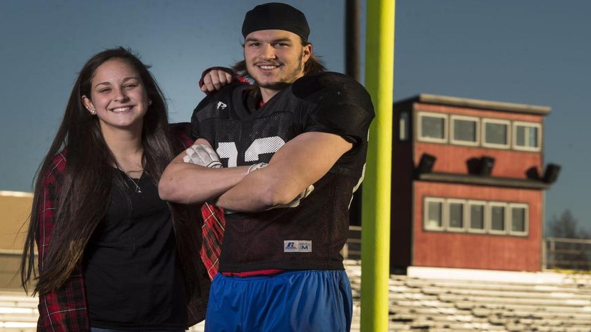 Krysten Smith (left) stands with her boyfriend, Kobe Hardin, one of the key players on the Odessa High School football team on Thursday at the high school football stadium. Odessa will play Aurora on Saturday in a Missouri Class 3 state semifinal playoff game.