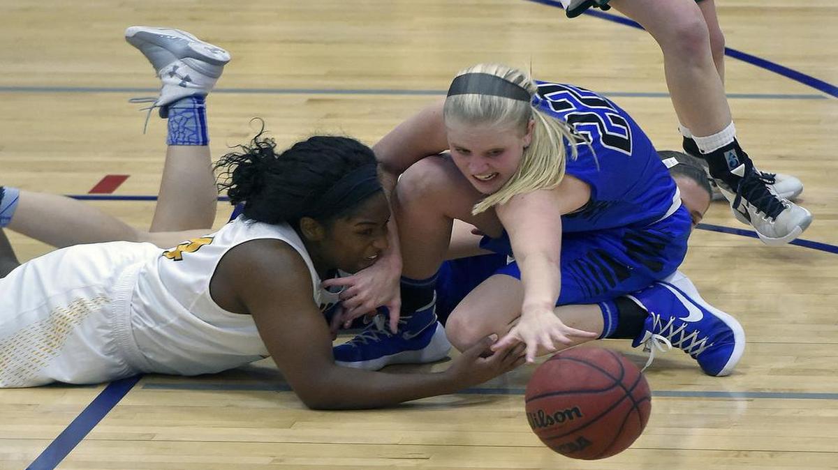 Liberty’s Morgan Fleming reached for a loose ball in front of Columbia Rock Bridge’s Bri Ellis last week during their game in the Truman Tournament.