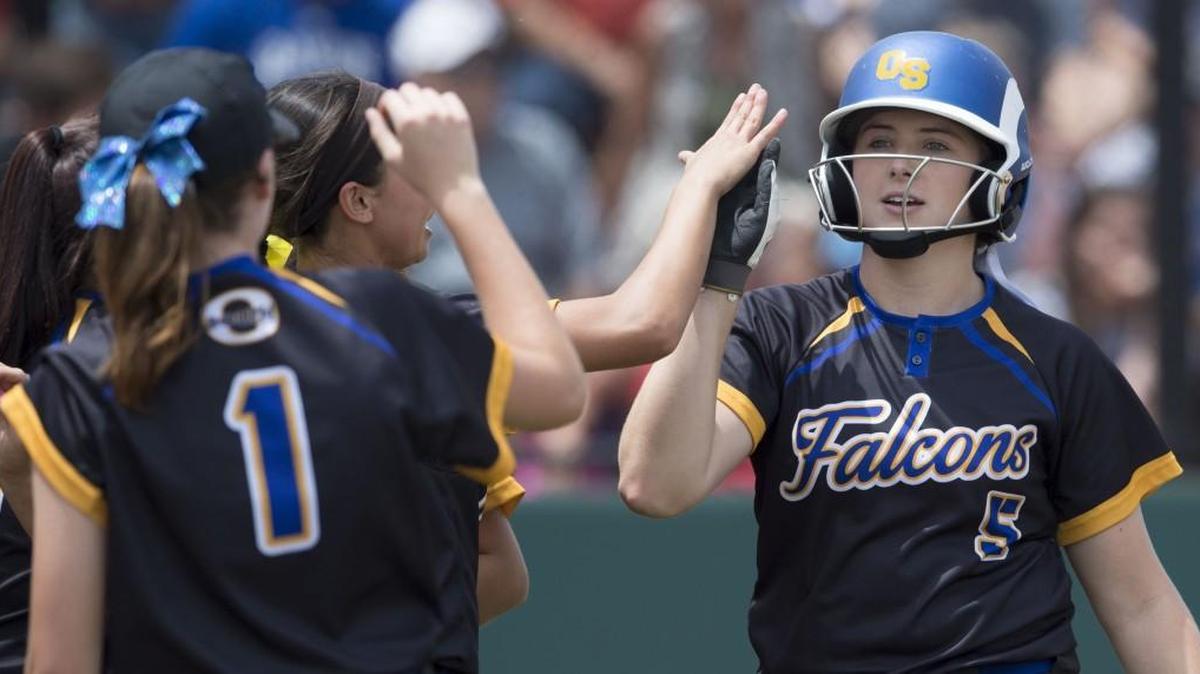 Olathe South’s Bailey Boxberger (right) celebrated with teammates after scoring on a triple by Kacey Kennett in the fifth inning during a Kansas 6A softball state semifinal game against Olathe Northwest on Friday at Blue Valley West.