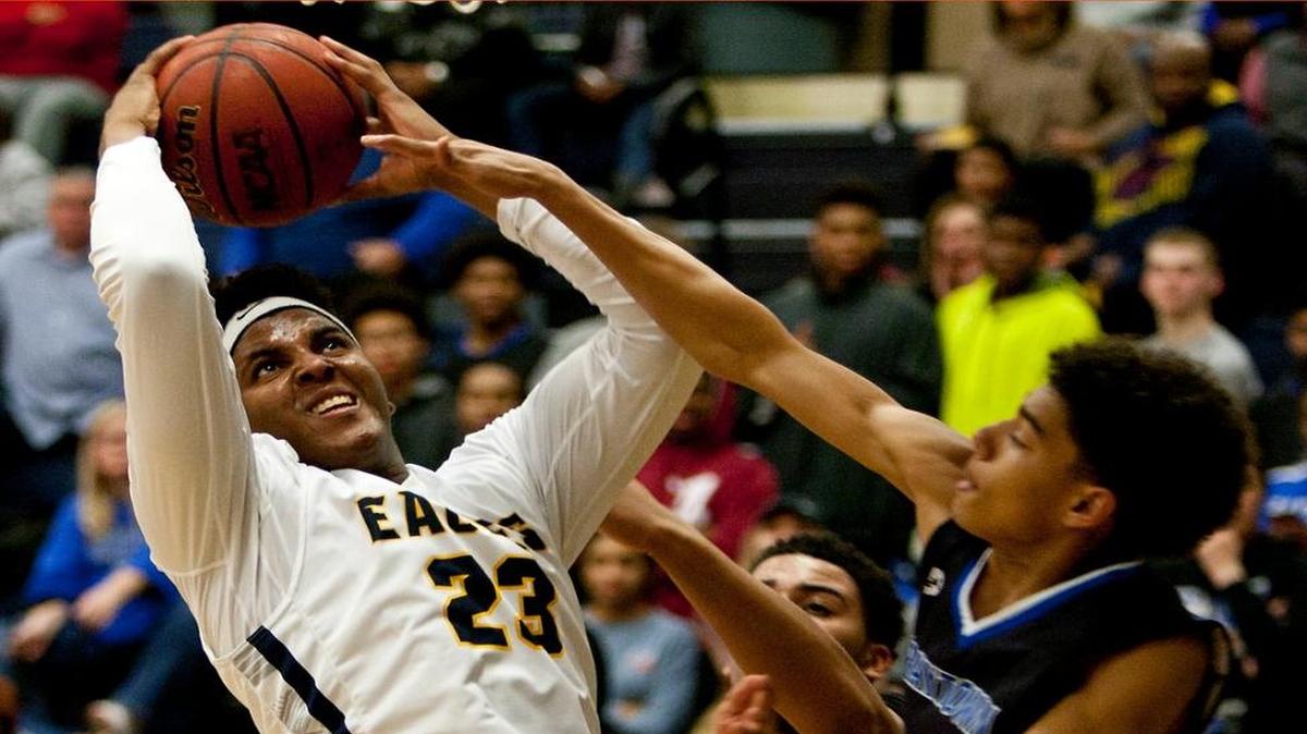 Senior Michael Hughes (left) made some key baskets inside for the Liberty North Eagles, who improved to 5-0 in Suburban Conference White Division games.