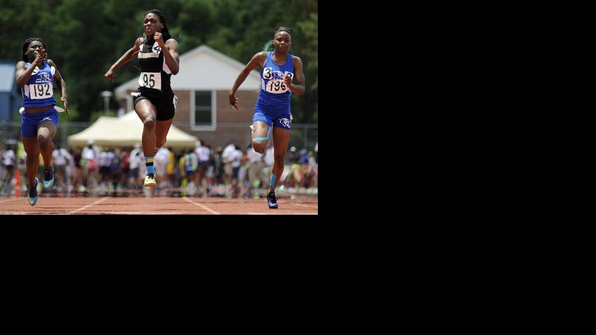 Grandview's Anglerne Annelus (center) accelerates to the finish line just ahead of Berkeley teammates Kamira Franklin, right, and Octavia Cato to defend her title in the girls 100-meter dash during the MSHSAA Class 4 State Track and Field Championships at Lincoln University's Dwight T. Reed Stadium in Jefferson City.