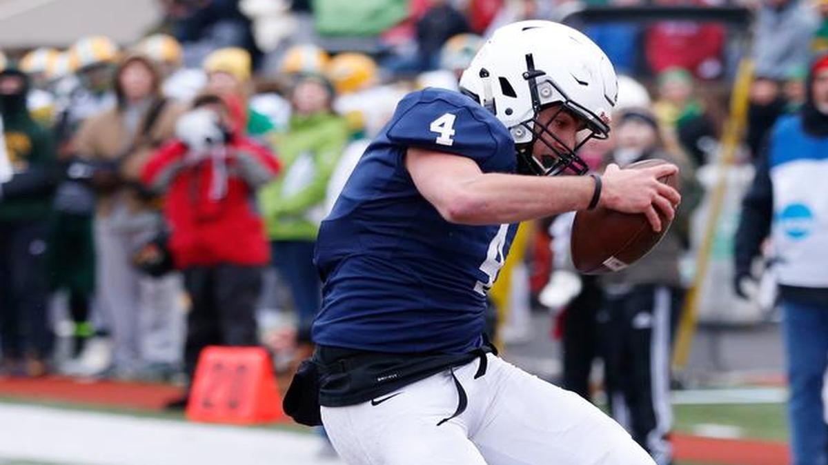Mill Valley quarterback Logan Koch shed a tackle by Bishop Carroll’s Ethan Green and scored a touchdown.