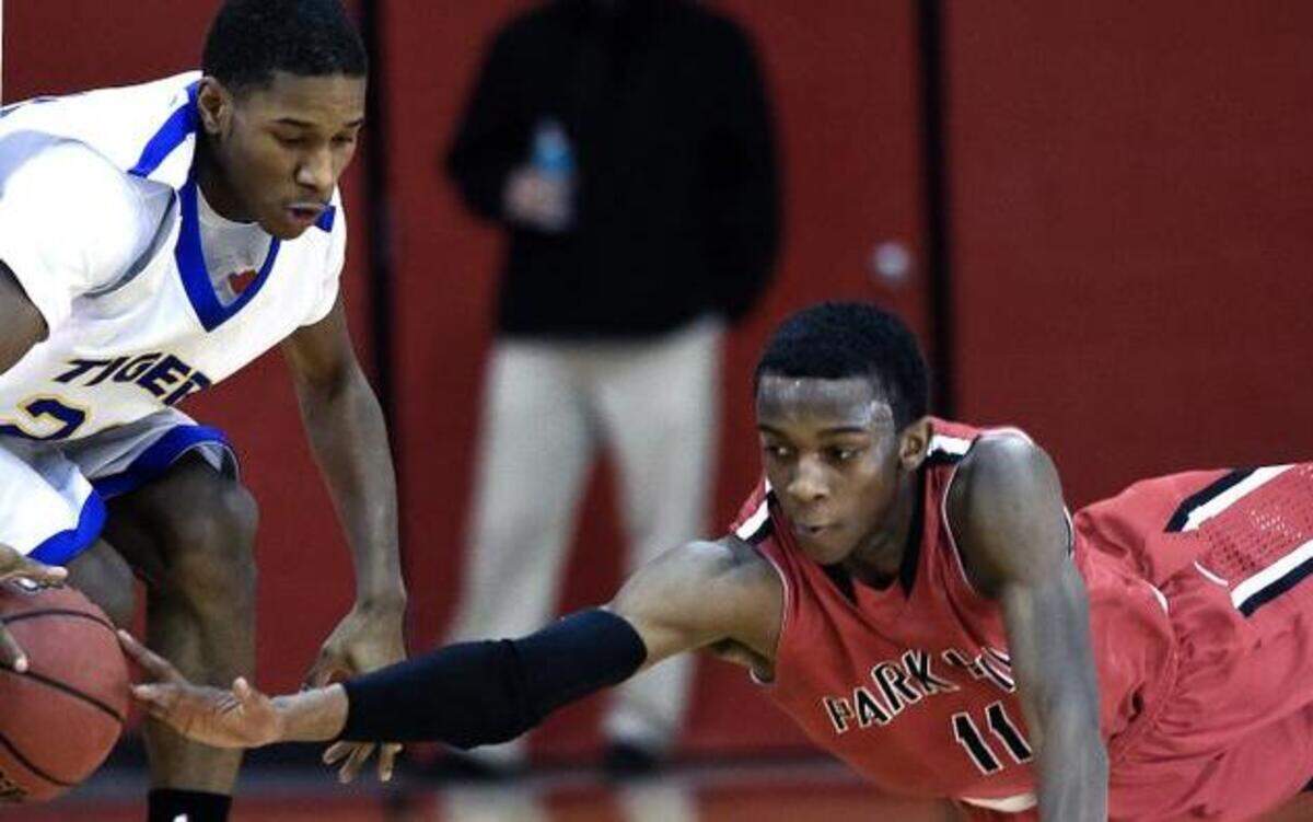 
Park Hill guard Deionte Wilson dived for the ball in front of Lincoln Prep guard Mylan Collins during Tuesday’s game.
