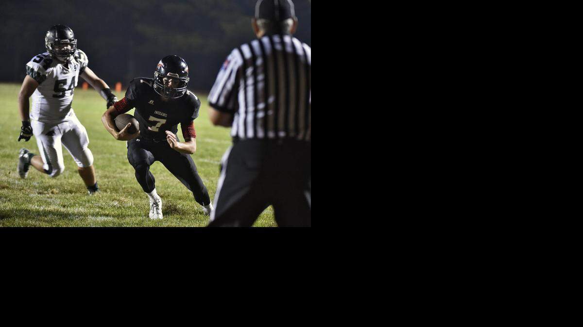 
Fort Osage High School quarterback Skylar Thompson (with ball) ran during second-quarter action in a game earlier this season against Staley.

