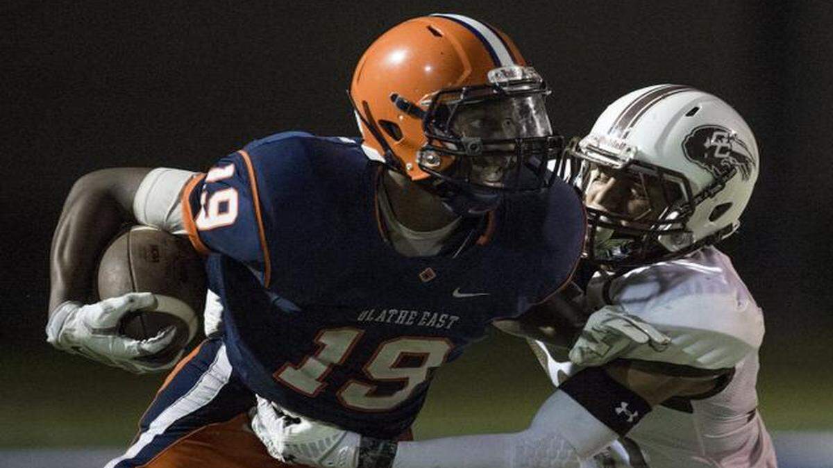 
Olathe East wide receiver Zac Cahill fought off a tackle by Garden City defensive back Gabe Otero during a game earlier this month.
