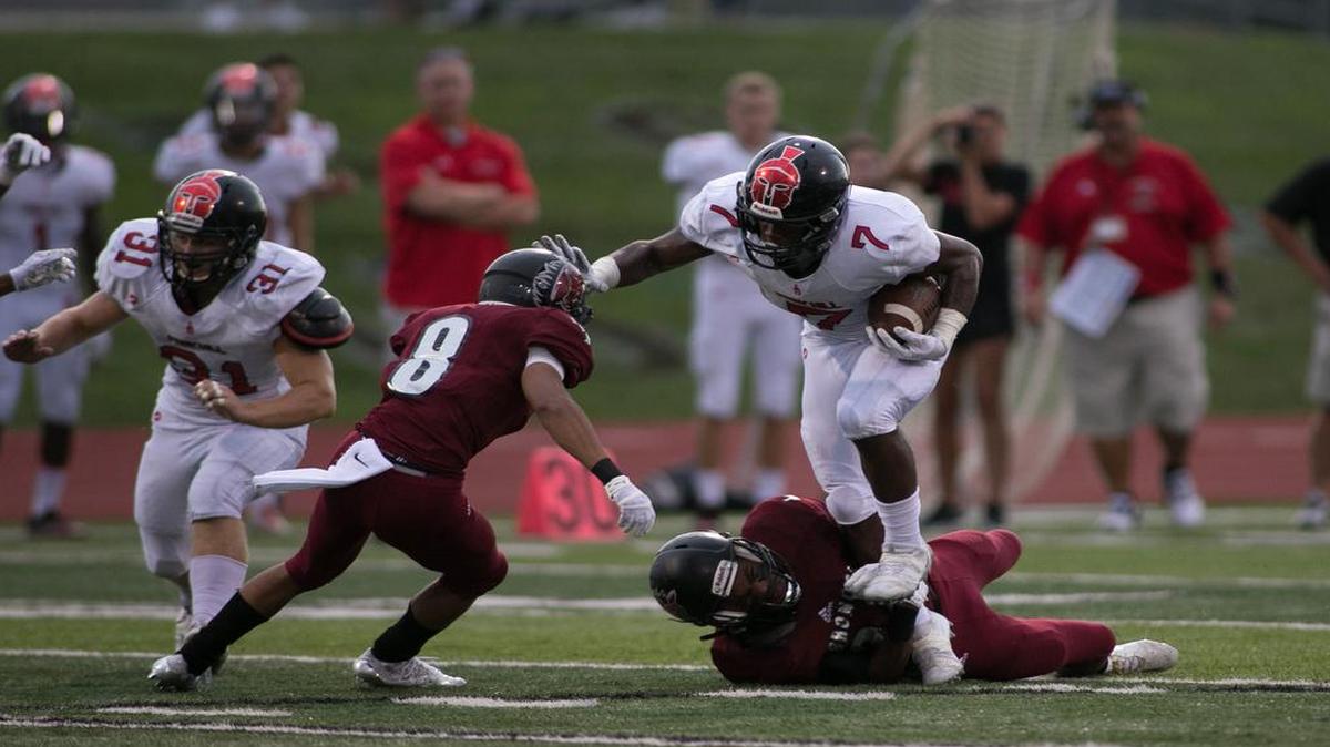 Park Hill senior running back Seven Wilson stiff-armed Nyles Thomas of Lee’s Summit North on his way to 15-yard run in last week’s football season opener for both teams.