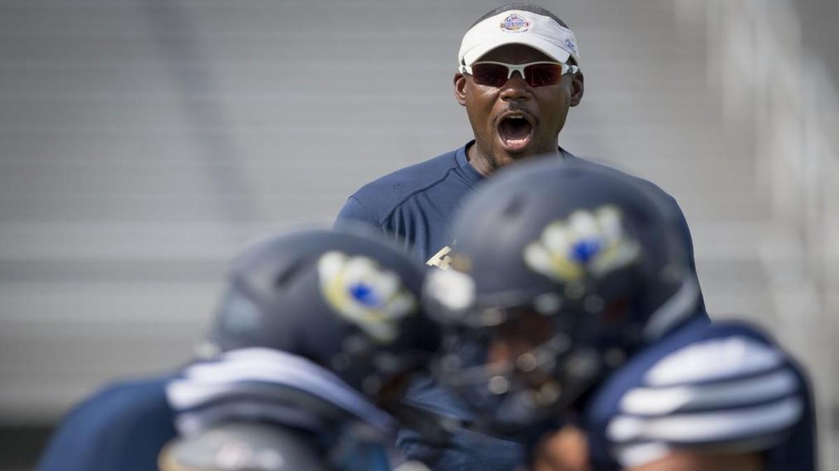 Scorpio Horn encouraged players to work a blocking drill during football practice at William Chrisman High School in September.