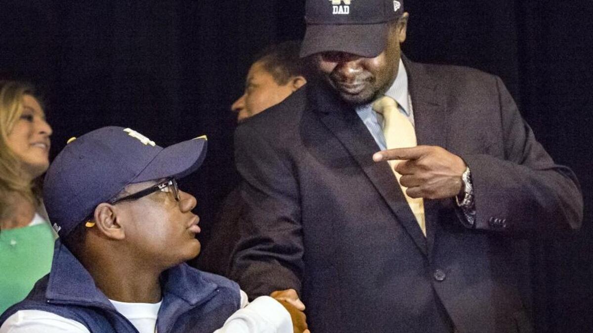 Bishop Miege wide receiver Jafar Armstrong was congratulated by his father, Jemal Armstrong, on Wednesday after he signed his letter of intent to play college football for Notre Dame surrounded by friends and family at the high school's auditorium. The highly recruited player committed in June to attend Missouri but changed his mind on Sunday, switching to the Fighting Irish.