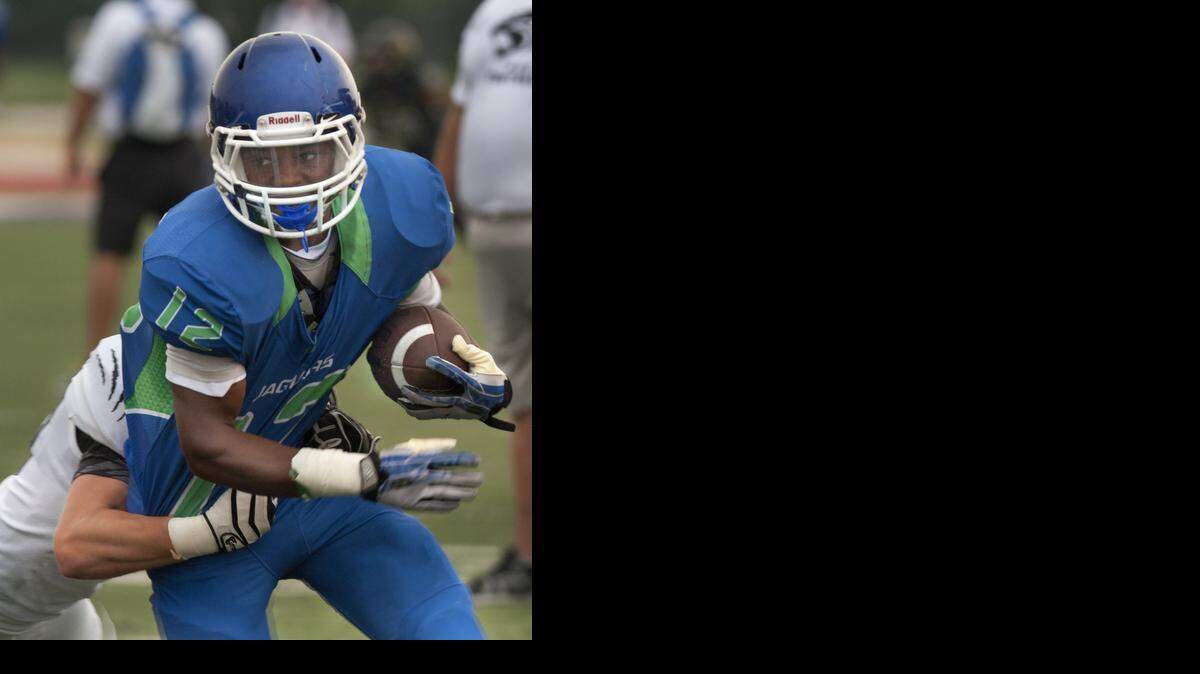 
Blue Springs South's Adam Cofield tried to shake a Park Hill South tackler on Friday during a jamboree at Park Hill High School.
