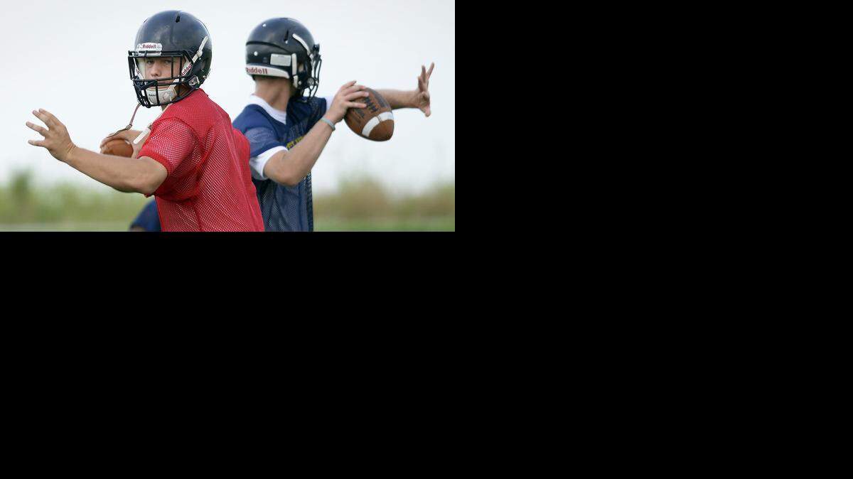 
Quarterbacks Brian Sharp (left) and Mitchell Miller went through passing drills during the first week of practice earlier this month at Liberty North High School. 

