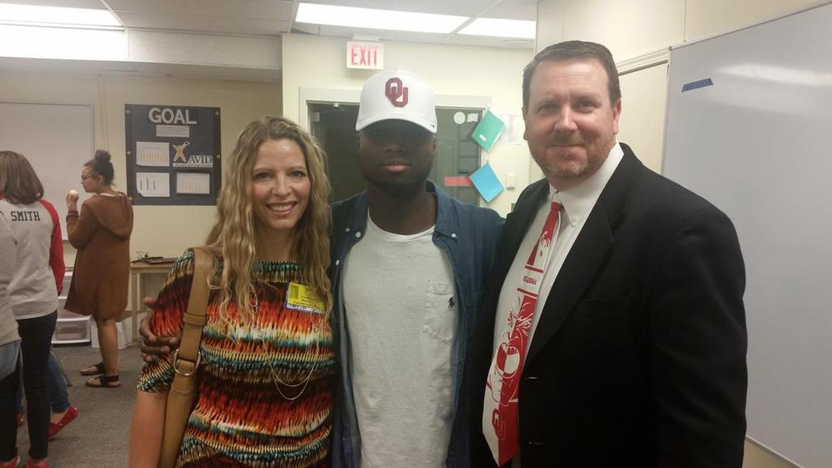 Papay Glaywulu (center) with his third-grade teacher, Kendra Carpenter (left), and his elementary school principal, Christopher Daniels.
