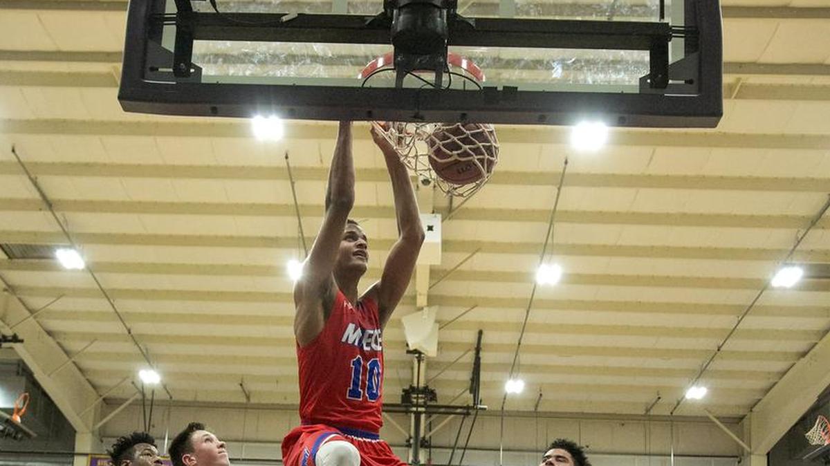 Bishop Miege’s Jeremiah Robinson-Earl got a dunk in the victory against Lee’s Summit North on Friday at Avila College in the Cable Dahmer Shootout.