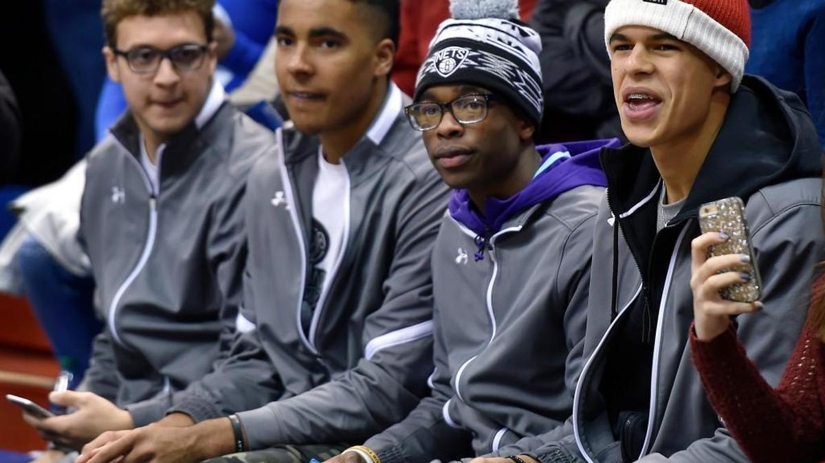 High school star Michael Porter (right) sat behind the KU bench to watch the Jayhawks’ 70-63 win over TCU.