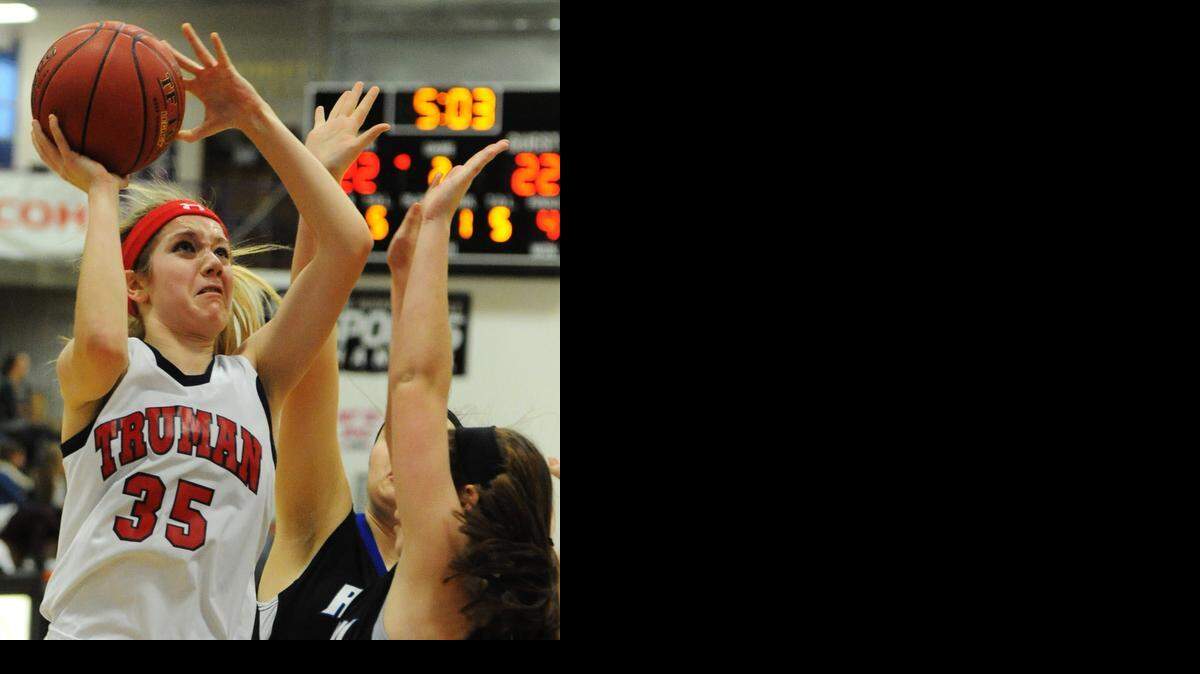 
Truman High School’s Briana Savidge shot over two Olathe Northwest defenders during their game in the Hy-Vee Shootout at Avila University.
