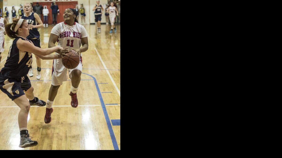 
Shelbe Piggie (right) of Bishop Miege is fouled on a drive to the basket by Rhyann Fisher of St. Thomas Aquinas during their basketball on Jan. 16 at Bishop Miege High School. The two teams will meet again on Monday.
