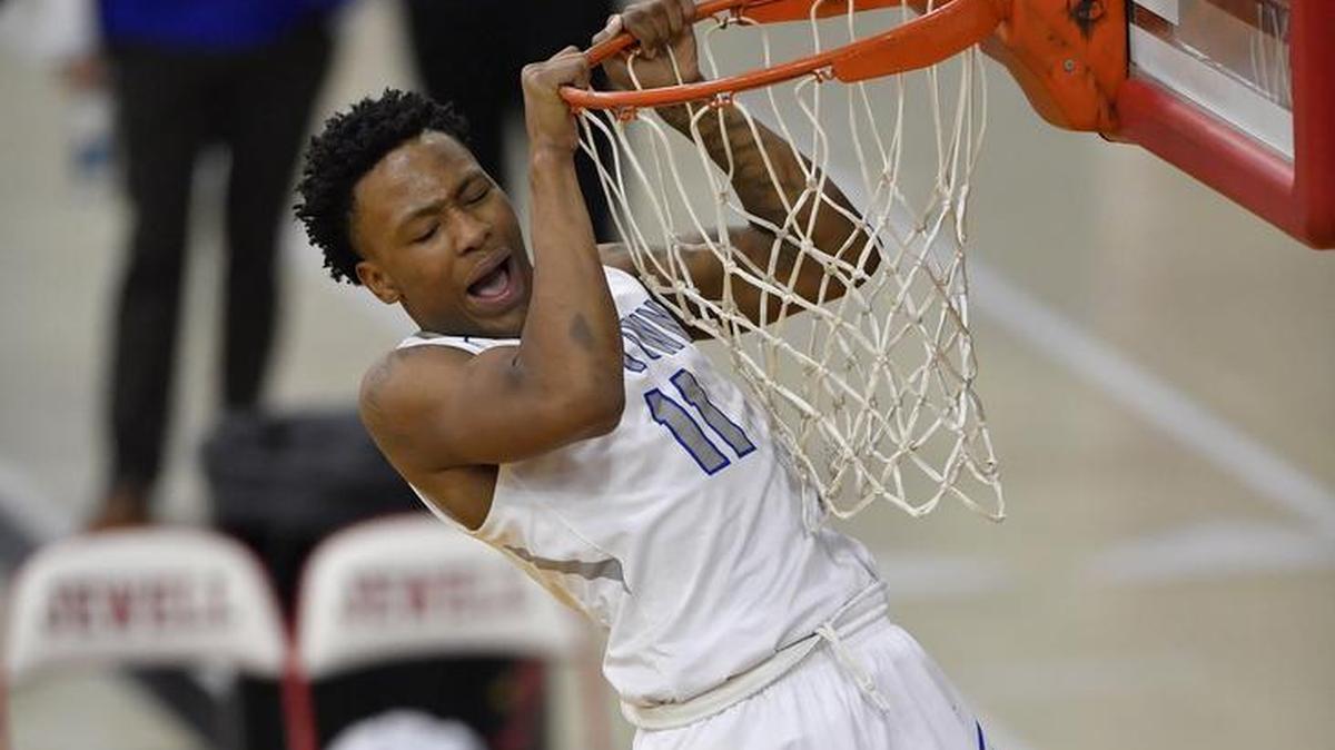 Raytown’s Desmond Hutson hung on to the rim after a big dunk down the stretch against Staley in the William Jewell Holiday Classic on Thursday.